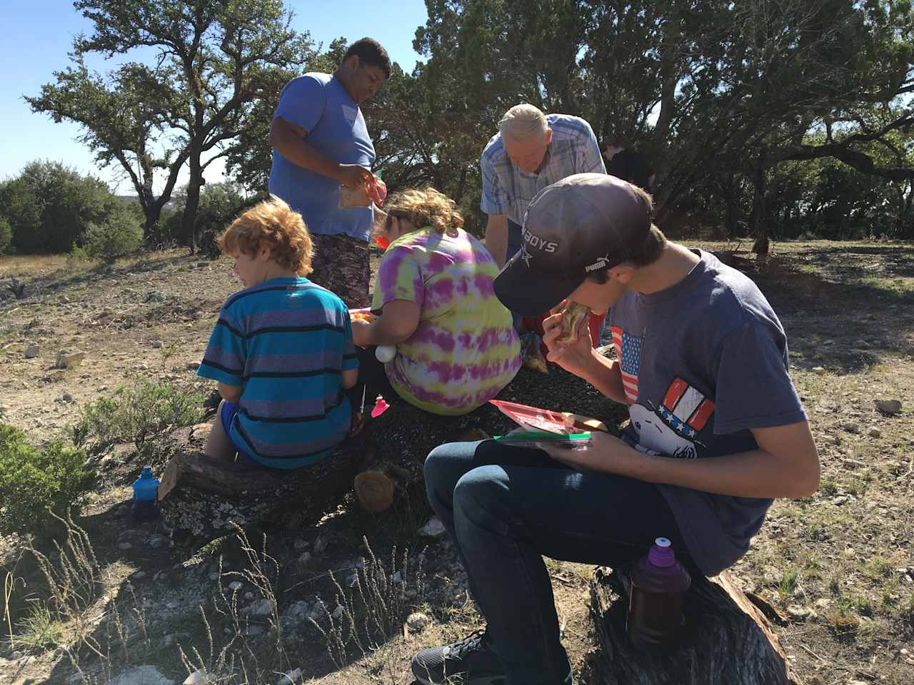 Grandkids eating sandwiches  on West Side/Cliff Side Of Lake! 